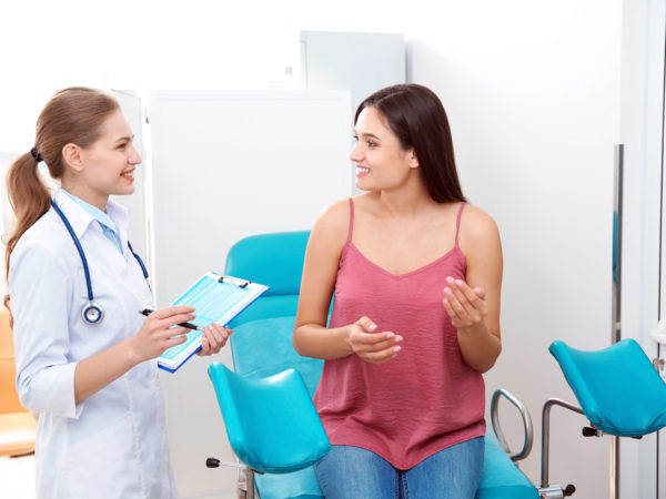 female doctor talking with female patient